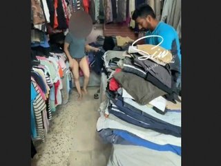 The shopkeeper observes as I attempt on